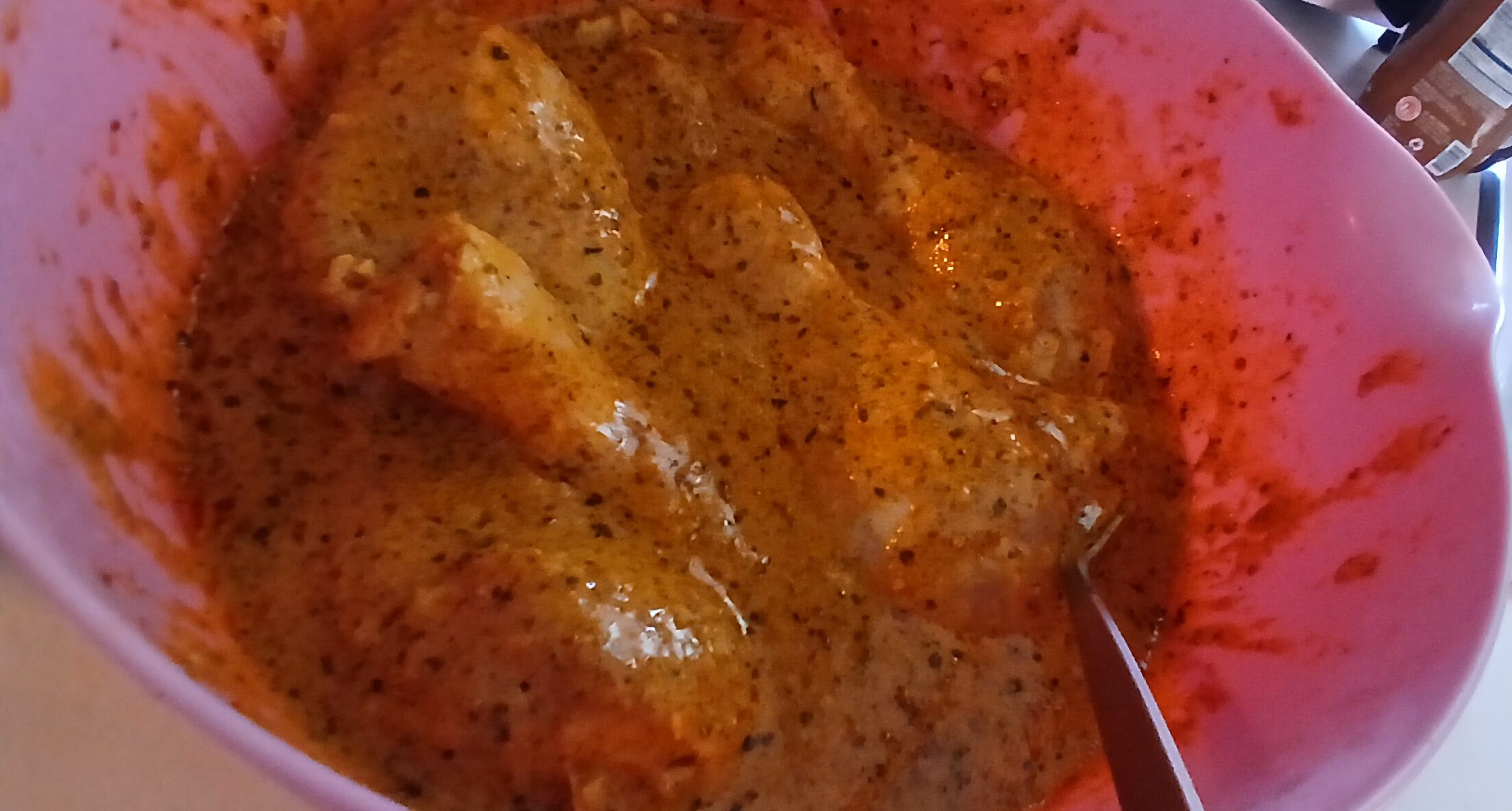 Juicy marinated chicken drumsticks on baking sheet