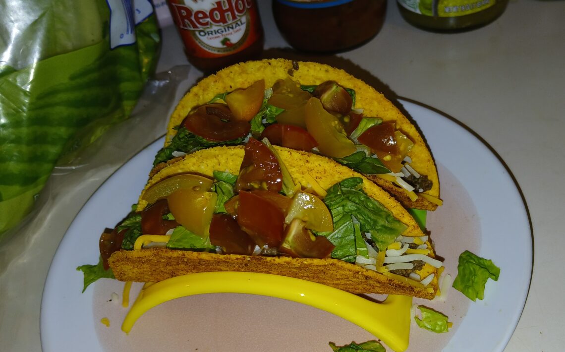 Hot and crunchy deer tacos with lettuce and tomato topping