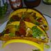 Hot and crunchy deer tacos with lettuce and tomato topping