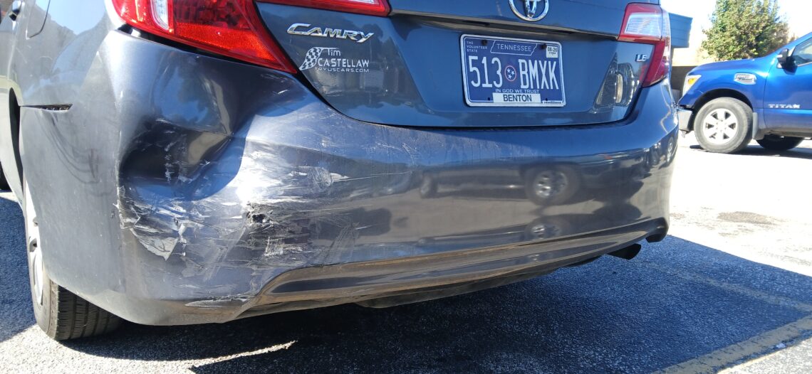 Rear bumper damage from a car wreck in Dickson, Tennessee, after being rear-ended at a yield sign. The vehicle shows visible impact from the collision.