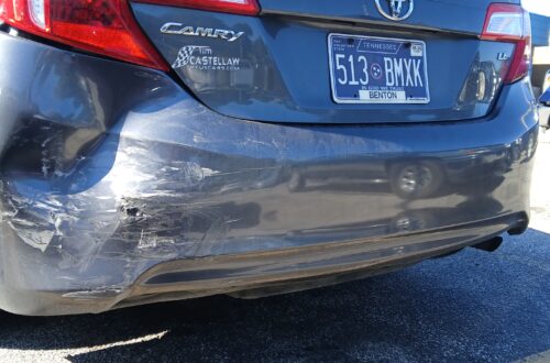 Rear bumper damage from a car wreck in Dickson, Tennessee, after being rear-ended at a yield sign. The vehicle shows visible impact from the collision.